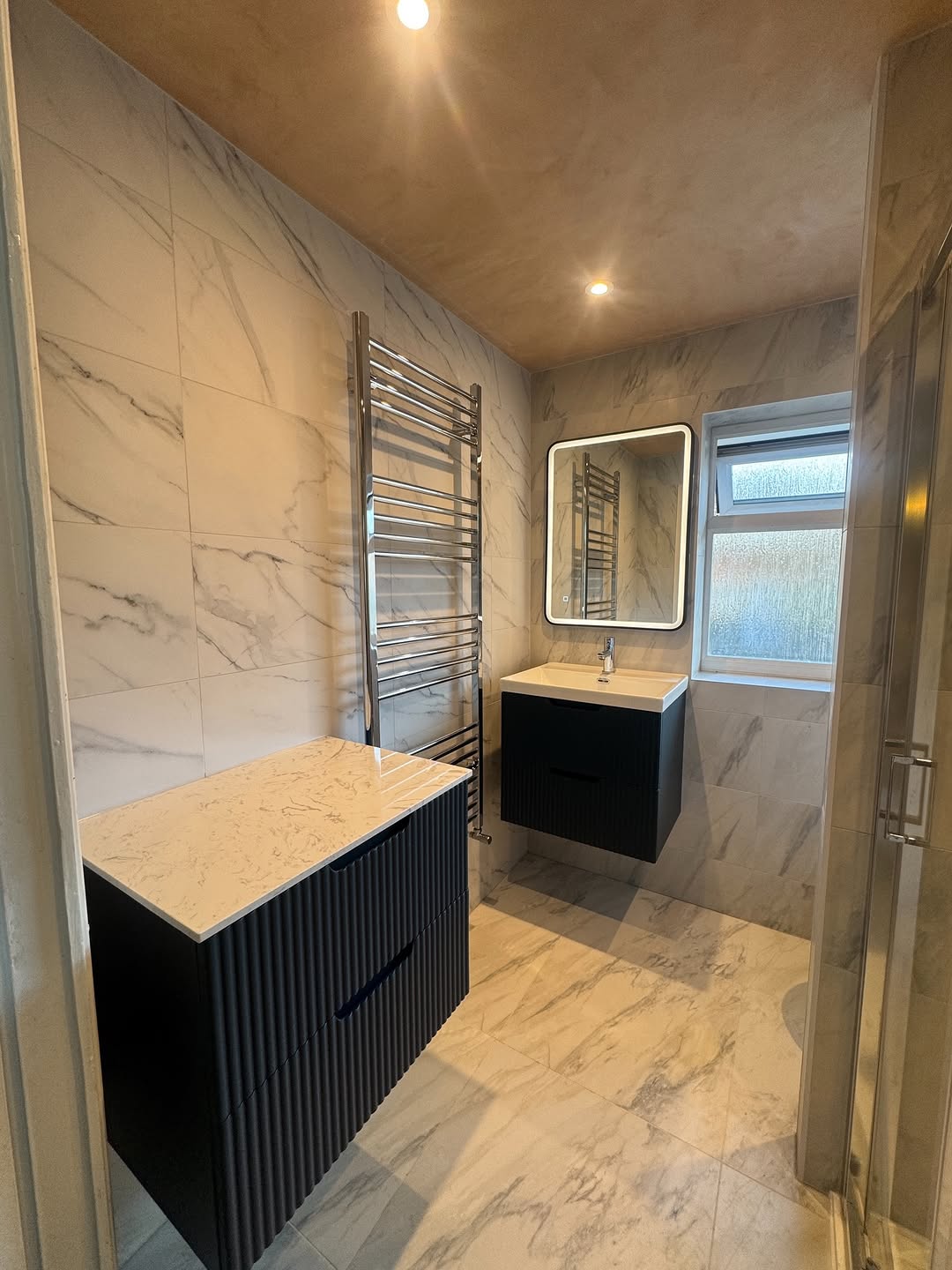 Marble bathroom with a black vanity